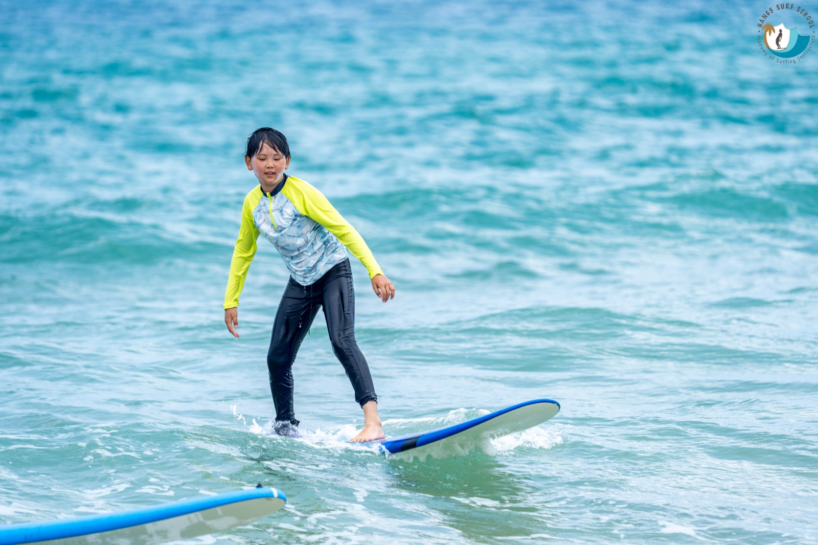 Alan Wang surfing on a wave