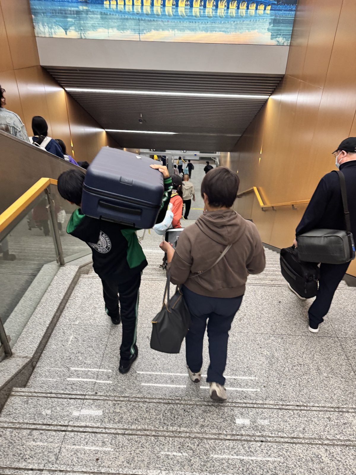 Alan Wang arriving with luggage on the way to Boston